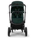 Bugaboo Fox 5 Renew complete bassinet and seat in black and fern green, featuring a spacious seat, harness, and large wheels.