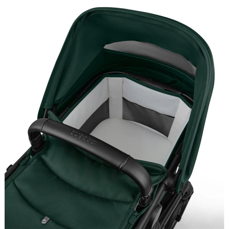 Bugaboo Fox 5 Renew Complete Bassinet & Seat in black and fern green, featuring a comfortable interior with a padded seat.