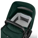 Bugaboo Fox 5 Renew Complete Bassinet & Seat in black and fern green, featuring a comfortable interior with a padded seat.