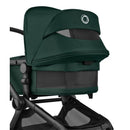 Bugaboo Fox 5 Renew Complete Bassinet and Seat in Black and Fern Green, showcasing the snug canopy and mesh paneling.