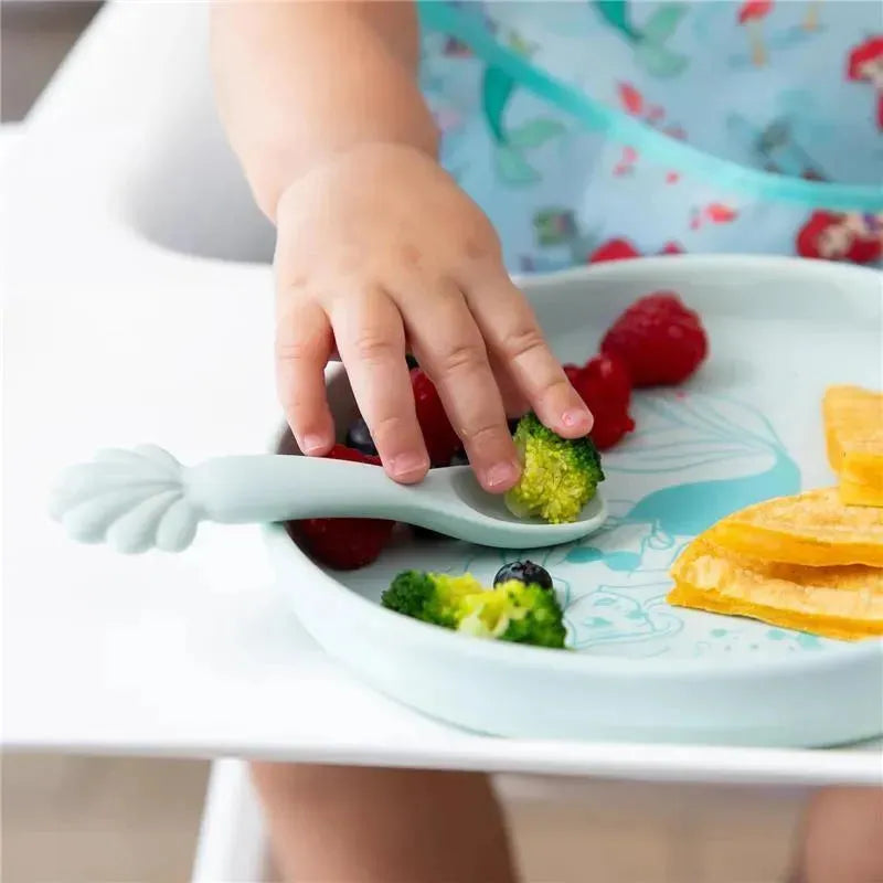 Silicone plate and spoon set featuring Princess Ariel, with a child reaching for broccoli and berries.