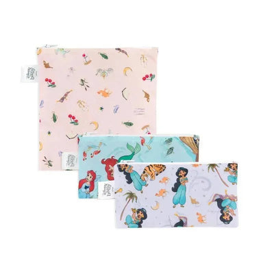 Three reusable snack bags featuring Disney Princess designs: Ariel in a light blue bag, Jasmine in a light purple bag, and a multicolored pattern on a pink bag.