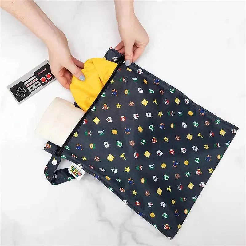 Bumkins Disney waterproof wet bag featuring a colorful Nintendo Super Mario print, being filled with a yellow item.