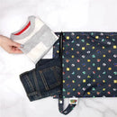 Bumkins Disney Waterproof Wet Bag featuring colorful Nintendo Super Mario designs, with folded clothes beside it.
