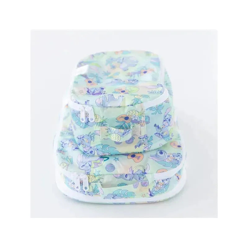 Two packing cubes in a pastel Aloha design, featuring tropical patterns and secured with white zippers.
