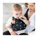 Silicone Bib featuring Mickey Mouse design, worn by a child being assisted by a caregiver during mealtime.