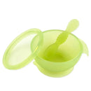 Silicone feeding set for babies and toddlers, featuring a suction bowl and matching spoon in translucent green.