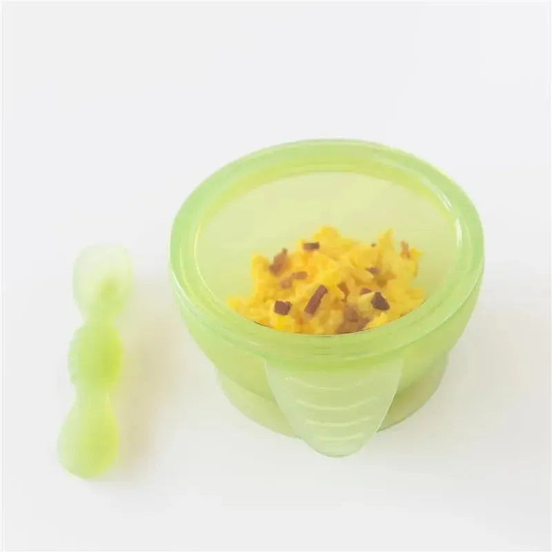 Bumkins silicone feeding set in green jelly, featuring a suction bowl filled with food and a matching spoon.