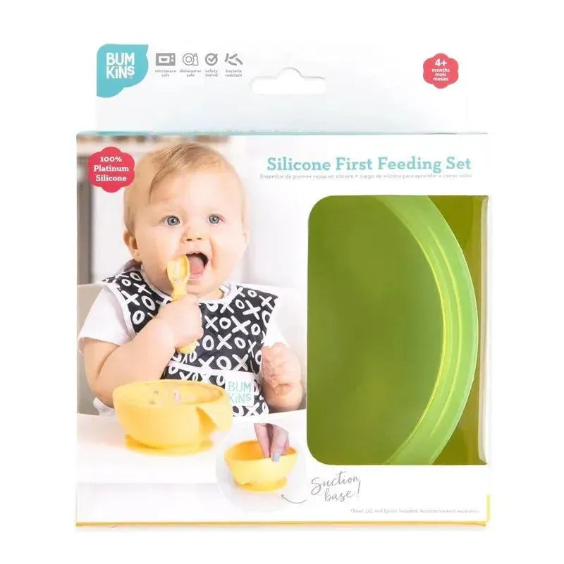 Silicone feeding set by Bumkins, featuring suction base, for babies and toddlers in green jelly, with a smiling baby using it.
