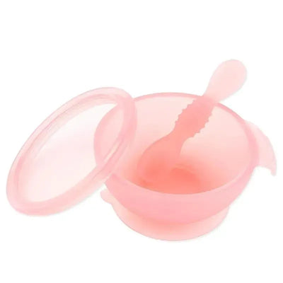 Silicone feeding bowl with suction base and spoon, both in pink, designed for babies and toddlers.