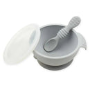 Silicone feeding bowl set in gray, featuring a bowl with a lid and a matching spoon. Ideal for first feeding experiences.