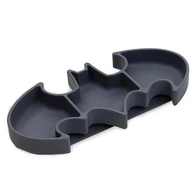 Silicone grip dish shaped like the Batman logo, featuring multiple compartments for food.