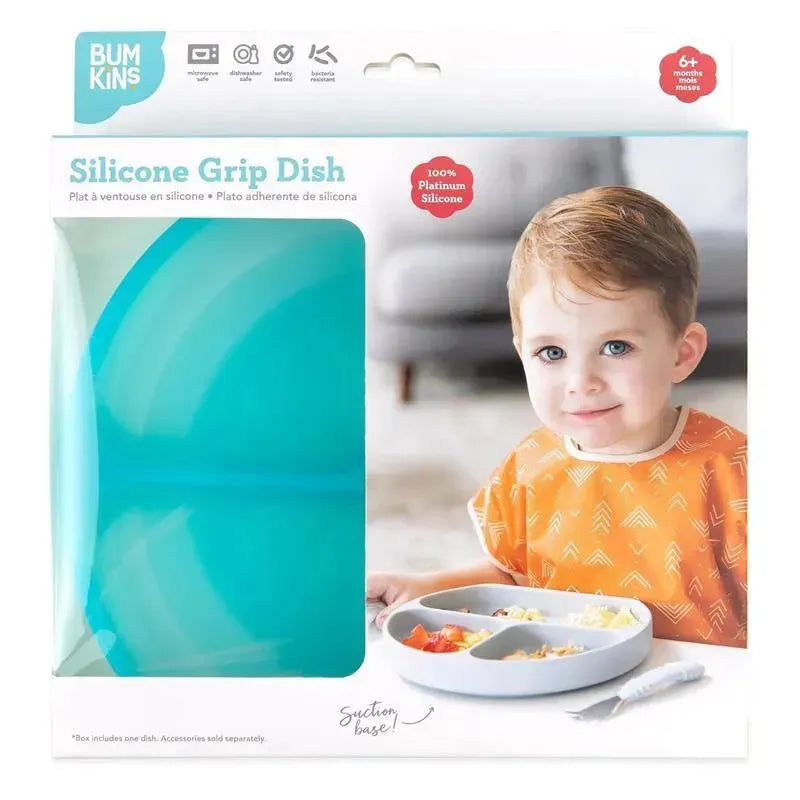 Bumkins Silicone Grip Dish in blue jelly packaging, featuring a child with light brown hair using a segmented dish for mealtime.