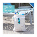 Bumkins Waterproof Wet Dry Bag filled with items, featuring blue sunglasses, on a poolside lounge area.