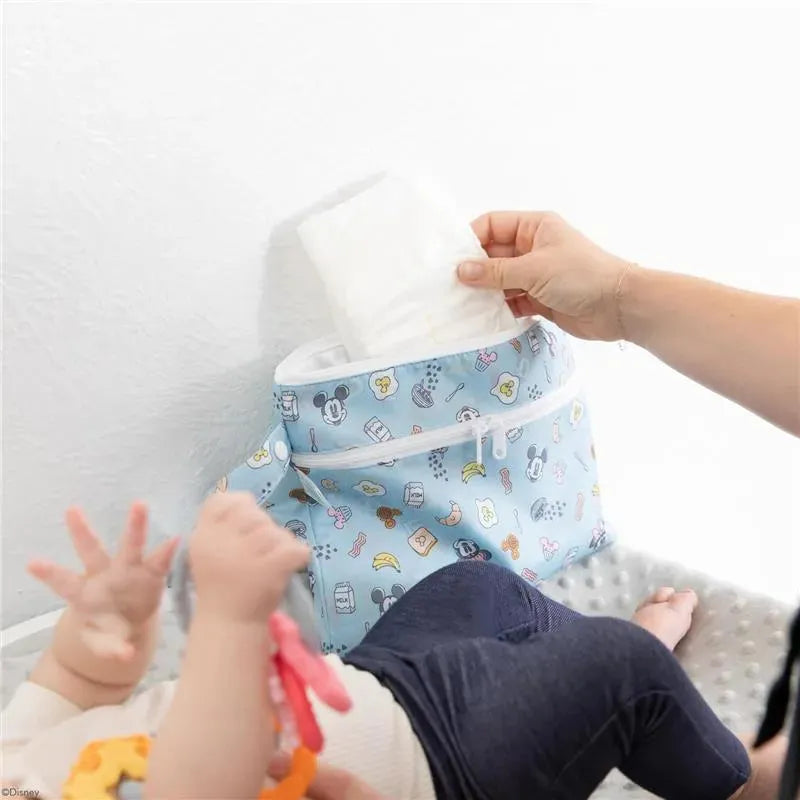 Bumkins Wet/Dry Clutch featuring Mickey and Minnie Mouse patterns, with a caregiver retrieving a wipe for a baby.