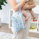 Bumkins Wet/Dry Clutch featuring Mickey and Minnie Mouse designs, held by a parent carrying a child.