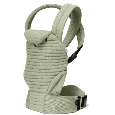 Bumpsuit The Armadillo Baby Carrier in Matcha color, featuring a textured fabric and adjustable straps.