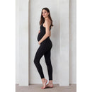 Black Kate Bumpsuit modeled by a pregnant woman, highlighting its comfortable fit and adjustable straps.