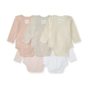 Five long sleeve bodysuits for baby girls in pink and neutral colors, featuring a label on the back.