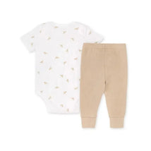 Baby Golden Bee bodysuit features a white design with small floral prints, paired with beige ribbed pants.
