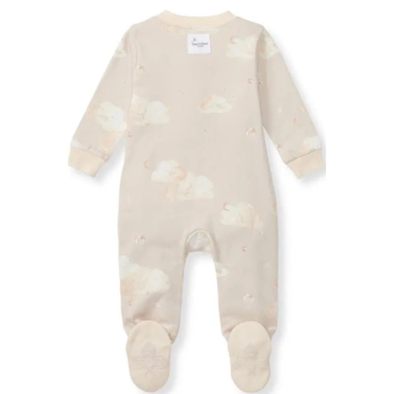 Baby sleep and play onesie in limestone color, featuring a cloud pattern and footed design with a tag at the neck.
