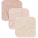Three organic cotton baby washcloths in pink sand shades, featuring a soft knit terry texture and a tag.