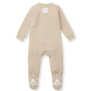 Baby unisex solid rib sleep and play in hummus color, featuring a tag on the back and decorative soles.