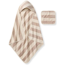 Organic cotton towel and washcloth set in oat color with alternating cream and light brown stripes.