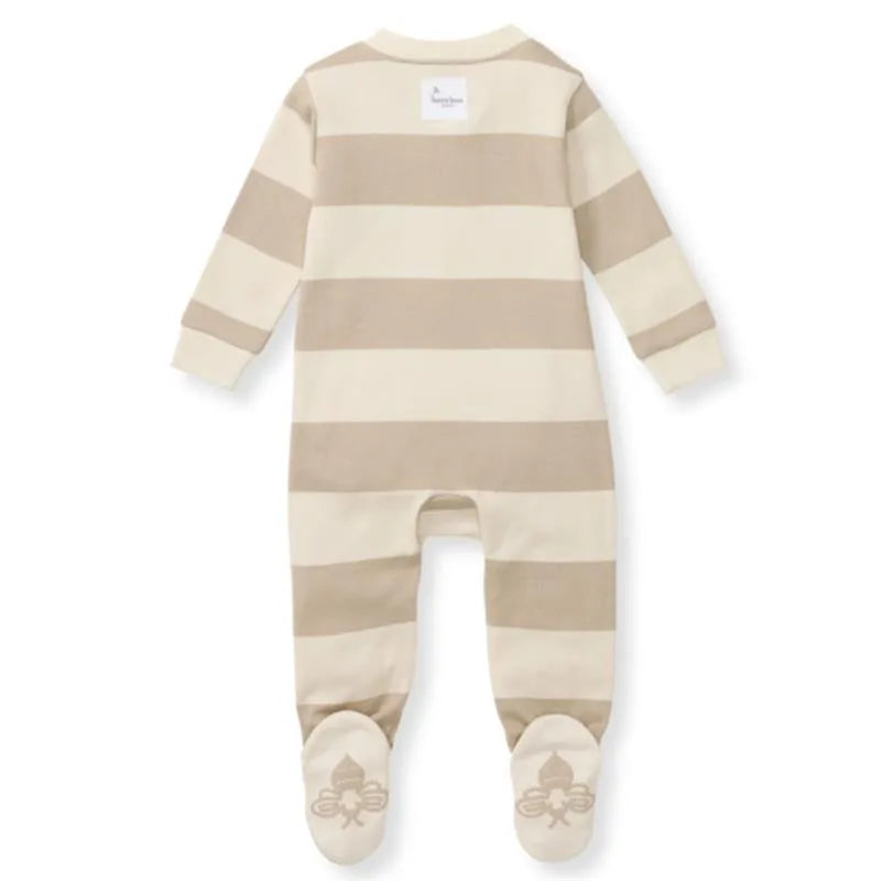 Rugby stripe baby sleep and play outfit in oat color, featuring light and dark stripes, with a tag on the back and footed design.