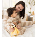 Mom and child share a joyful moment in matching striped outfits, with the child holding a bee-themed security blanket.