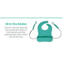 Premium spearmint silicone baby bib with straps for utensils and toys, featuring a comfortable design and catch-all pocket.