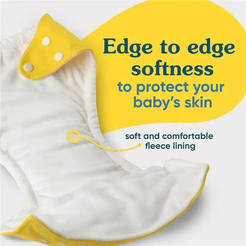 Reusable cloth diaper with yellow snaps, featuring soft fleece lining and text highlighting edge-to-edge softness for baby’s comfort.