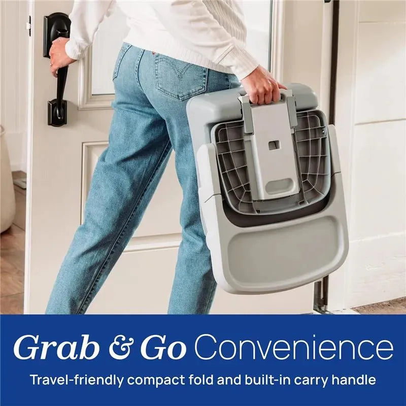 Chicco Bento 3-In-1 Booster Seat in Sage, shown being carried with a built-in handle, emphasizing its travel-friendly design.