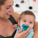 Chicco Physioforma orthodontic silicone pacifier in blue/green held by a smiling mother with her baby.
