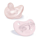 Two Chicco Physioforma orthodontic silicone pacifiers in soft pink, designed for infants 0-6 months, featuring heart-shaped holes and a clear handle.