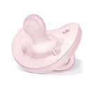 Soft pink silicone pacifier with orthodontic design for infants 0-6 months, featuring ventilation holes and a smooth surface.