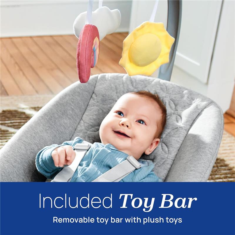 Baby in a gray Chicco Float Baby Seat smiles while reaching for a removable toy bar featuring plush cloud and sun toys.