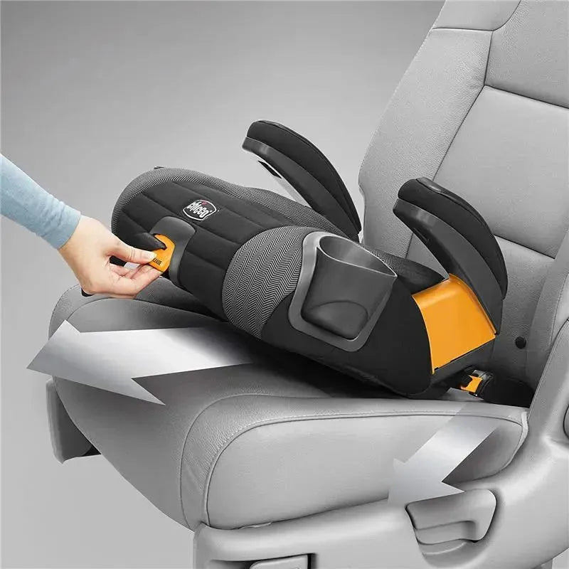 Chicco GoFit Plus Backless Booster Car Seat in Stream color, securely positioned in a vehicle with a hand adjusting the latch.