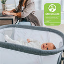 Chicco LullaGlide 3-in-1 Stationary Baby Bassinet with a smiling baby in a cozy white outfit; GREENGUARD certified for low chemical emissions.