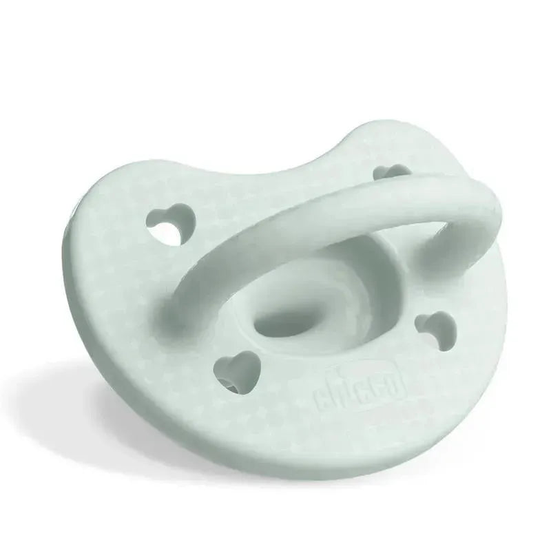 Mint green Chicco PhysioForma pacifier for babies 0-6 months, made of 100% soft silicone, featuring heart-shaped holes.