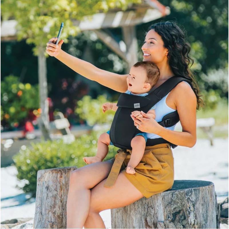 Woman taking a selfie while using a black Chicco Snugsupport 4-In-1 Infant Carrier with a smiling baby.
