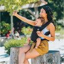 Woman taking a selfie while using a black Chicco Snugsupport 4-In-1 Infant Carrier with a smiling baby.