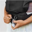 Woman adjusting the Chicco Snugsupport 4-In-1 Infant Carrier in black, showcasing its adjustable features.