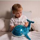 Blue Eco Tranquil Whale plush toy being interacted with by a child, featuring a soft surface and a light projection on top.