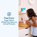 A woman gently cares for a baby in a basket, with text highlighting that the product is free from sugar, gluten, and animal products.