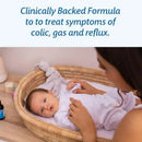 Clinically backed formula for treating colic, gas, and reflux, with a baby in a basket and a caregiver gently holding their hand.