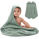 Hooded towels in fern color, featuring a baby playfully wrapped in one, highlighting softness and comfort.