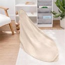 Hooded towel set in sand color, displaying soft, layered texture with a child playing in the background.