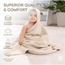 Hooded towel made of 6 layers of soft muslin wrapped around a baby, showcasing superior quality and comfort.