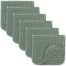 Six soft, fern-colored muslin burp cloths arranged in a stack, showcasing their textured and quilted design.